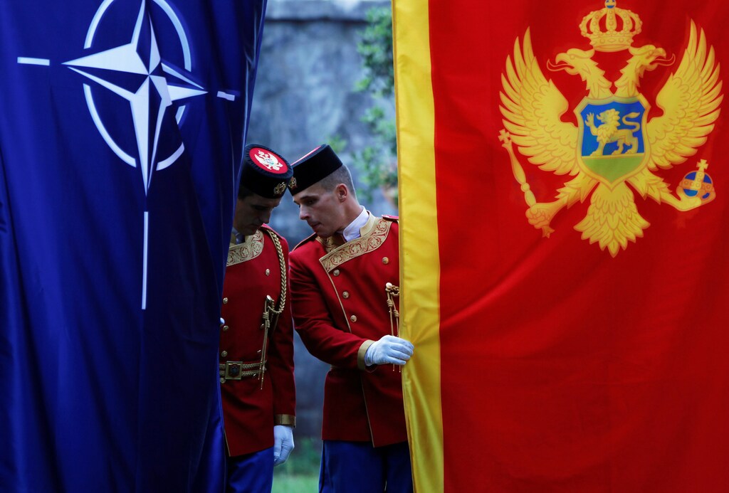Montenegrin guard of honor inspect NATO and Montenegro flags prior to a ceremony to mark the accession to NATO of Montenegro in Podgorica, Montenegro, June 7, 2017. REUTERS/Stevo Vasiljevic - RTX39II4