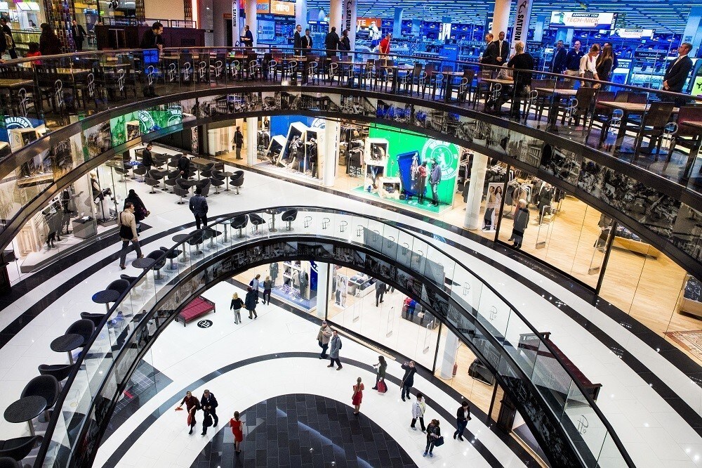 People walk through the Mall of Berlin shopping centre during its opening night in Berlin, September 24, 2014.