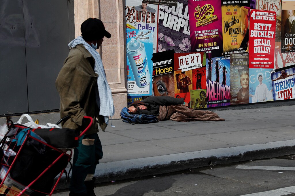 A man sleeps on the sidewalk amid an outbreak of the coronavirus disease (COVID-19), in San Francisco, California, U.S. March 27, 2020. Picture taken March 27, 2020.