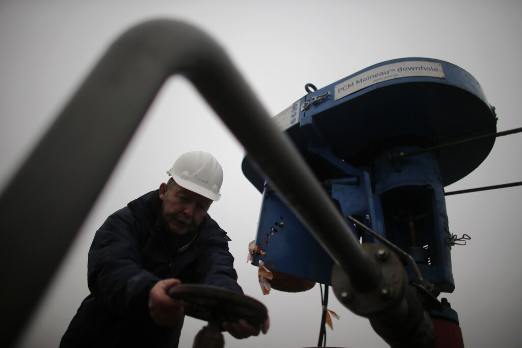 An employee of European Gas Limited works on British company's coalbed methane exploration site outside Folschviller, eastern France, February 4, 2013. After slamming the door to potentially huge shale gas reserves over environmental concerns, France has now discovered there could be at least five years worth of another cheap-to-produce gas in the former coal mining region of Lorraine. But, divisions in the French government, as with shale gas, are hampering efforts to develop so-called coalbed methane, a gas extracted from layers of coal too deep underground to be mined. Picture taken February 4, 2013. REUTERS/Christian Hartmann (FRANCE - Tags: ENERGY ENVIRONMENT BUSINESS INDUSTRIAL) - PM1E92E1EXR01