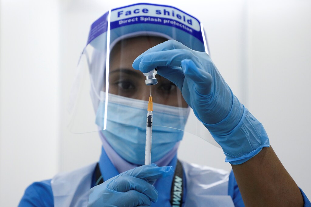 A medical worker prepares a dose of a vaccine for the coronavirus disease (COVID-19)