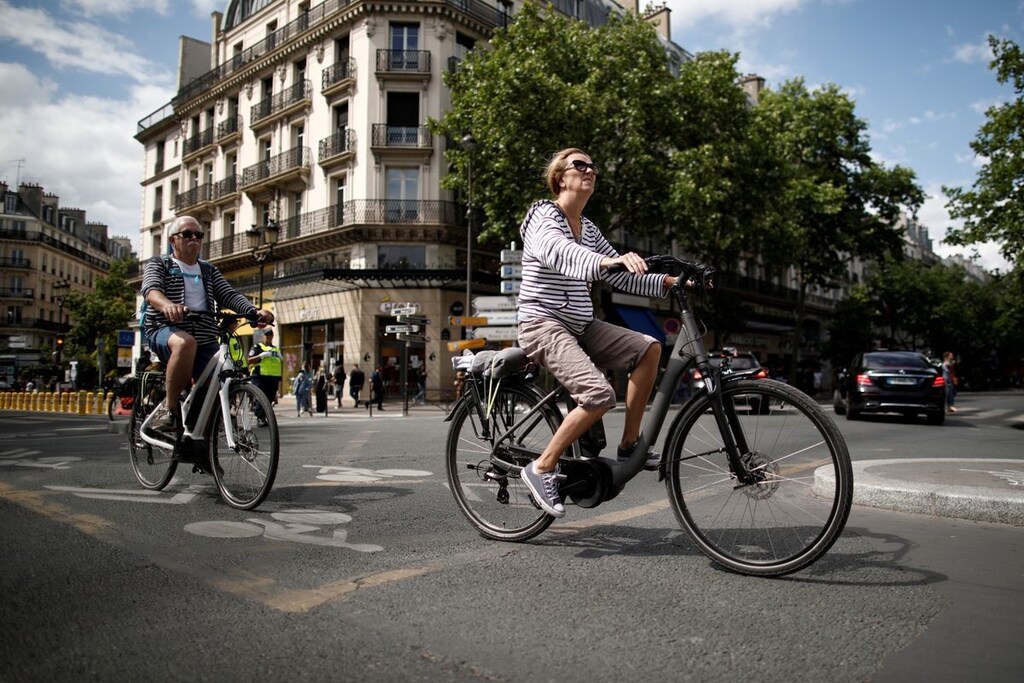 image of a woman riding an electric bike in Paris