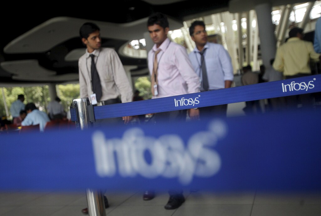 Employees of Indian software company Infosys walk past Infosys logos at their campus in the Electronic City area in Bangalore in this September 4, 2012 file photo. REUTERS/Vivek Prakash/Files GLOBAL BUSINESS WEEK AHEAD PACKAGE- SEARCH 'BUSINESS WEEK AHEAD APRIL 11' FOR ALL IMAGES - RTX29CXU