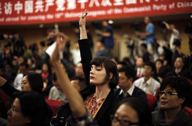 A foreign journalist raises her hand to ask a question during a news conference with Jiang Weixin, minister and secretary of the CPC Leadership Group of the Ministry of Housing And Urban-Rural Development, during the 18th National Party Congress (NPC) in Beijing November 12, 2012. At the last congress in 2007, top officials took one-on-one interviews, overseas reporters were encouraged to ask questions on whatever subject they wished and government media handlers went out of their way to be helpful, hoping to burnish China's global image ahead of the 2008 Olympic Games. This year, while economic officials and business leaders have generally been willing to talk, provincial leaders and rising political stars have largely shunned international media, and in some cases tried to avoid talking in public at all. REUTERS/Carlos Barria (CHINA - Tags: POLITICS MEDIA) - GM1E8BD183D01