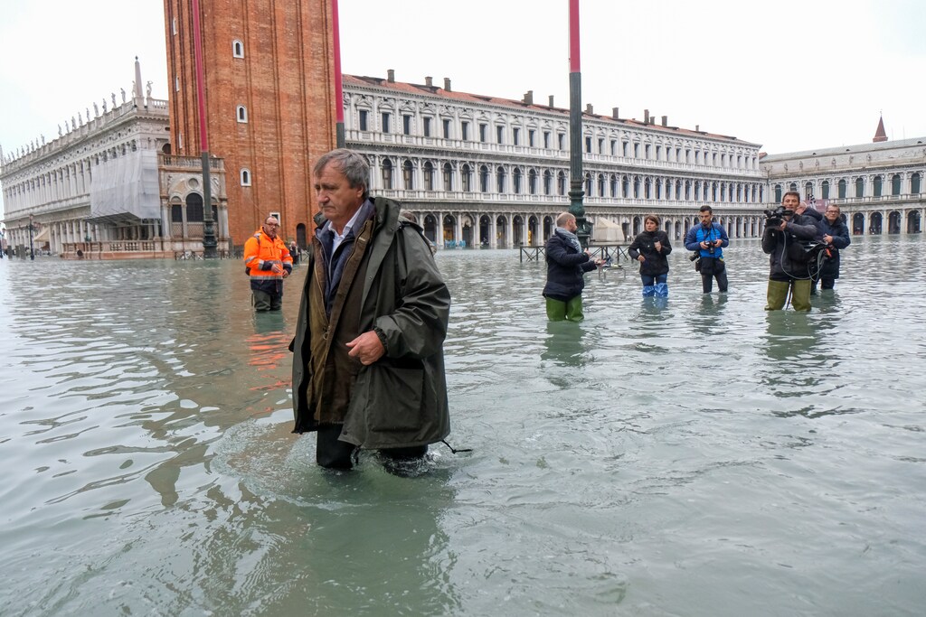 The Mayor of Venice Luigi Brugnaro walks on St Mark's Square during an exceptionally high water levels in Venice, Italy November 13, 2019. REUTERS/Manuel Silvestri - RC29AD9VIB5S