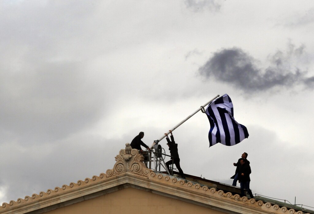 Greek parliament employees raise a mast after they replaced torn-off Greek flag with a new one atop the parliament in Athens Syntagma (Constitution) square April 18, 2012.Greeks go to the polls in about two weeks and at stake is Greece's willingness to impose harsh measures and exit the crisis. The winner(s) must convince international lenders that there will be no relaxing of austerity policies and reforms or risk bailout installments needed to keep Greece afloat. REUTERS/Yannis Behrakis (GREECE - Tags: BUSINESS POLITICS) - GM1E84J009E01