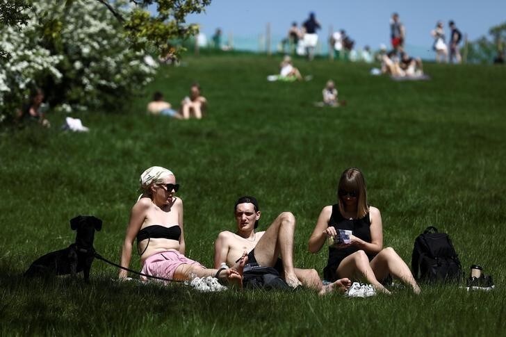 People sunbathe in hot weather on Primrose Hill in London, Britain May 7, 2018. REUTERS/Simon Dawson