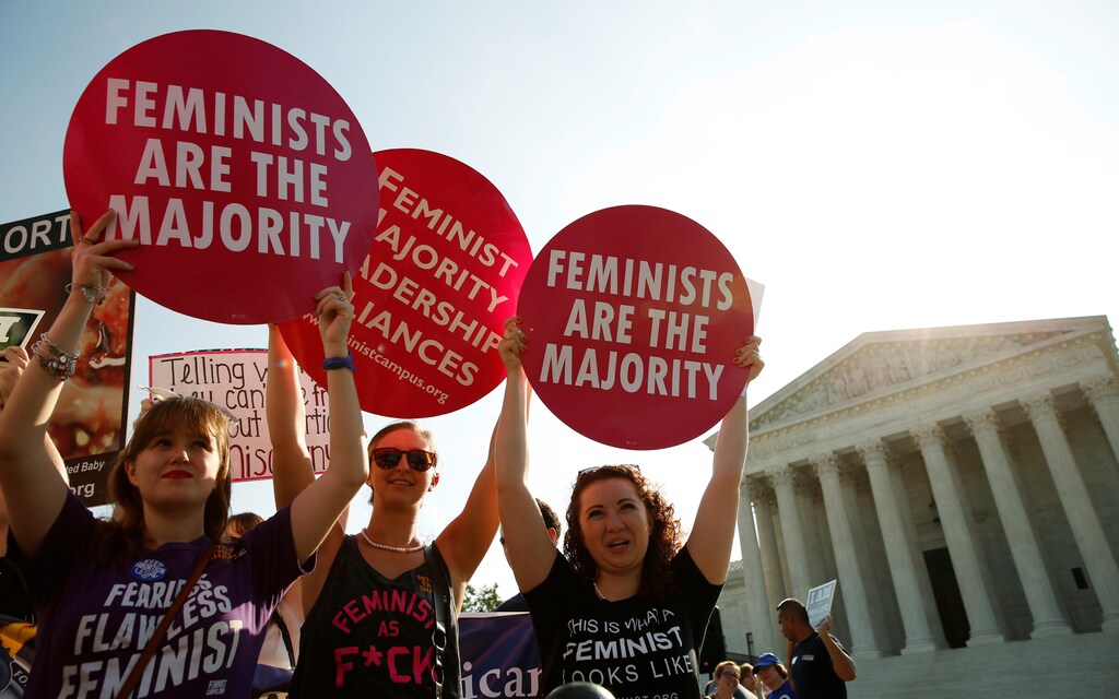 Demonstrators hold signs outside the U.S. Supreme Court as the court is due to issue its first major abortion ruling since 2007 against a backdrop of unremitting divisions among Americans on the issue and a decades-long decline in the rate at which women terminate pregnancies in Washington, U.S. June 27, 2016. REUTERS/Kevin Lamarque - D1AETMHXRXAB