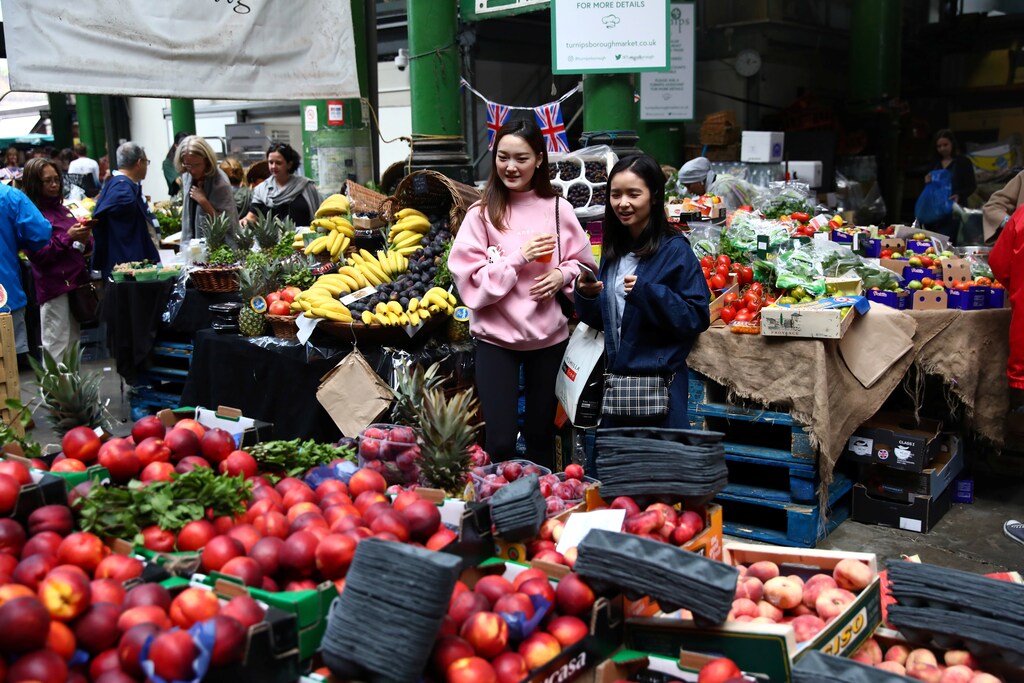 People walks through Borough Market in London, Britain August 18, 2017. REUTERS/Neil Hall - RC1458827B10