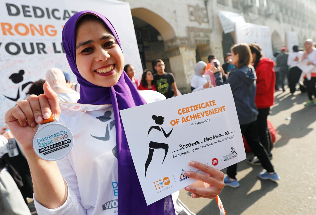 Ghosoun Mamdouh, a 21-year-old holds her medal after finishing the first Egyptian womens' race, to raise awareness about violence against women, in Cairo, Egypt, November 30, 2018. REUTERS/Amr Abdallah Dalsh - RC1C05127F30