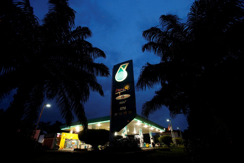 FILE PHOTO: The Petronas logo is seen at one of its petrol outlets in Putrajaya outside Kuala Lumpur December 8, 2012. REUTERS/Bazuki Muhammad/File Photo GLOBAL BUSINESS WEEK AHEAD PACKAGE Ð SEARCH BUSINESS WEEK AHEAD MARCH 13 FOR ALL IMAGES - RTX30QHY