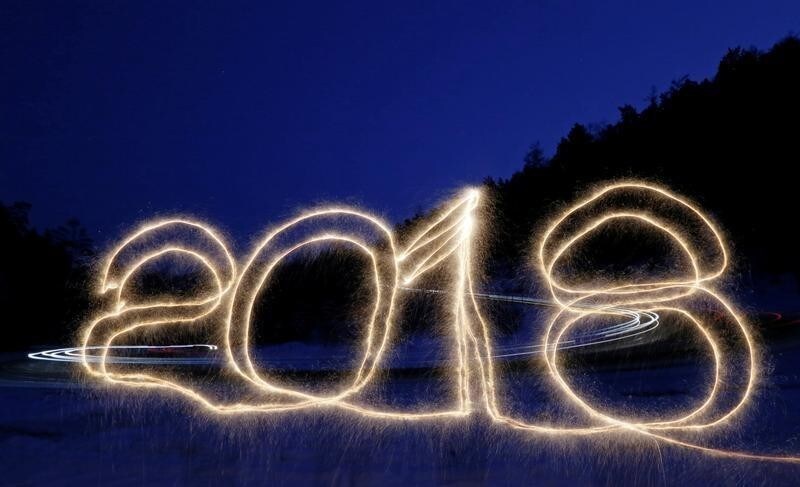 The numbers "2018" are written in the air with a sparkler on a roadside while cars drive along the R257 "Yenisei" federal highway in the Siberian Taiga district outside Krasnoyarsk, Russia January 1, 2018. Picture taken with long exposure. REUTERS/Ilya Naymushin TPX IMAGES OF THE DAY - RC1F0E430000