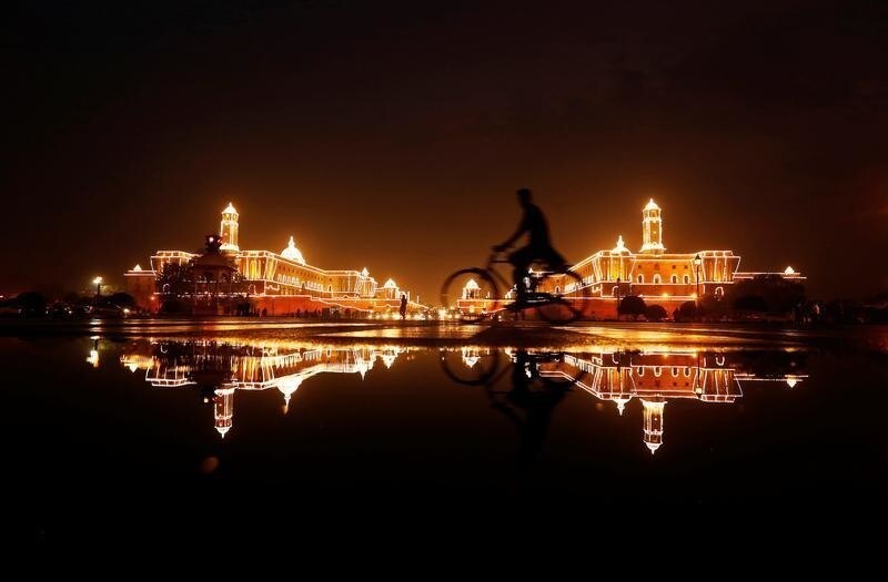 A cyclist rides past the Illuminated Indian Defence Ministry (L), Presidential Palace (C) and Home Ministry ahead of Indias Independence Day celebrations in New Delhi, India, August 13, 2016. REUTERS/Adnan Abidi - S1AETVFPPCAA