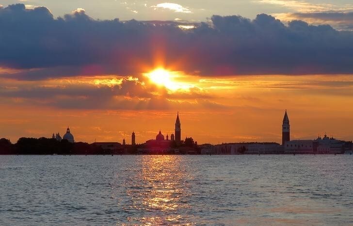 The city skyline of Venice is seen during the sun sets in the Venetian lagoon, Italy, June 20, 2016.