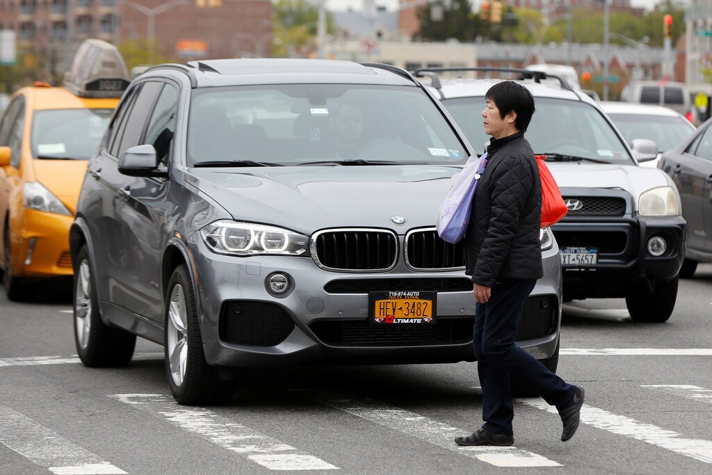 A woman walks across a crosswalk along Queens Boulevard in the borough of Queens in New York, U.S., May 5, 2016. REUTERS/Shannon Stapleton - RTX2E0NT