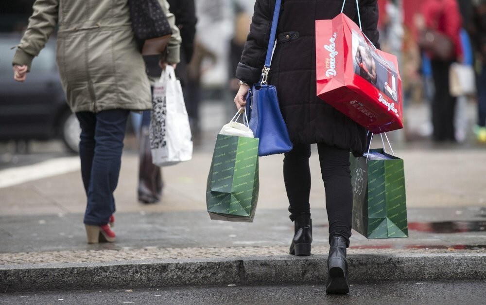 People carry bags outside a shopping mall on the last day of Christmas shopping in Berlin December 23, 2014.