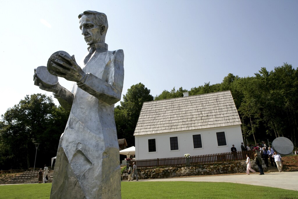 THIS PICTURE IS 5 OF 7 TO ACCOMPANY INSIGHT: POWER/ACDC. SEARCH IN YOUR PICTURE SYSTEM FOR KEYWORD "EDISON" TO SEE ALL IMAGES. (PXP100-106)A newly erected monument of Croatian Serb scientist Nikola Tesla stands in front of his renovated house in Smiljan, central Croatia, July 10, 2006. The American inventor Thomas Alva Edison, who made the incandescent light bulb viable for the mass market, also built the world's first electrical distribution system, in New York, using 'direct current' electricity. DC's disadvantage was that it couldn't carry power beyond a few blocks. His Serbia-born rival Nikola Tesla, who at one stage worked with Edison, figured out how to send 'alternating current' through transformers to enable it to step up the voltage for transmission over longer distances. Picture taken July 10, 2006. To match Insight POWER/ACDC REUTERS/Matko Biljak/Files (CROATIA - Tags: SCIENCE TECHNOLOGY ENERGY) - GM1E7CK1HIR01