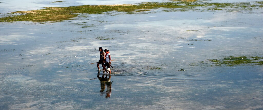 A woman fishing in Dili, Timor-Leste, Southeast Asia