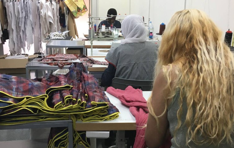 Women make clothes at the Dona Kolors social enterprise in Barcelona, June 20, 2019. Thomson Reuters Foundation/Sophie Davies
