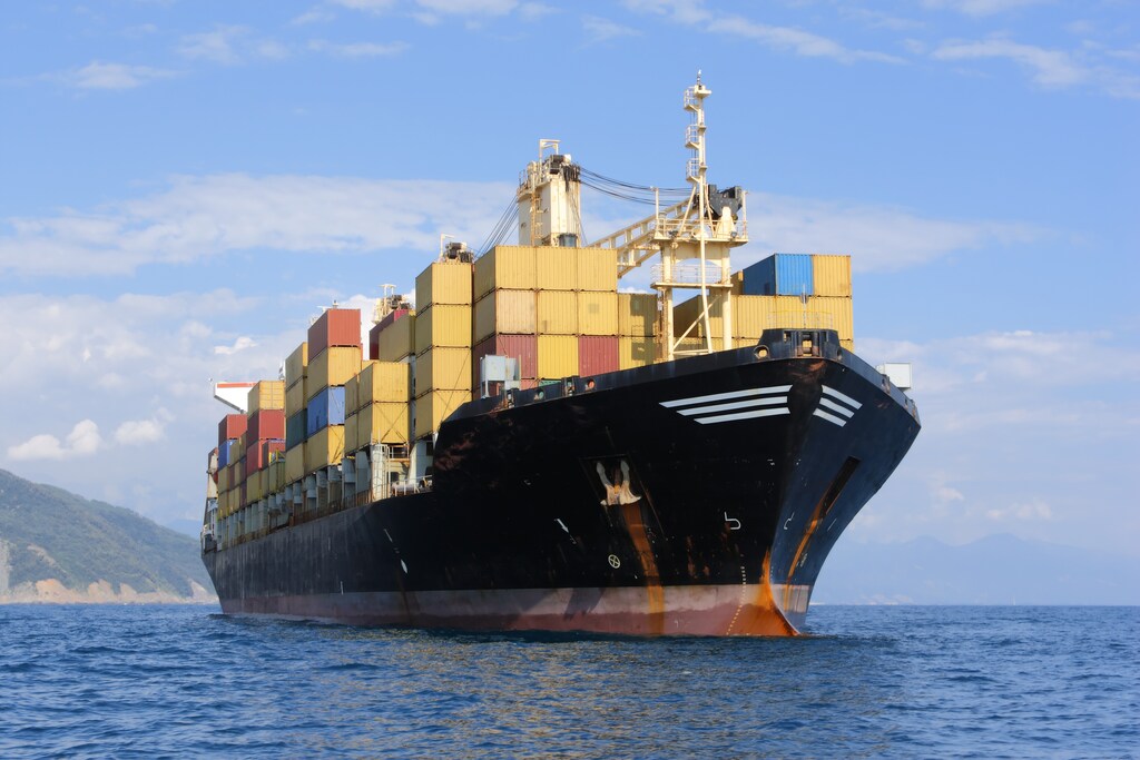 A cargo ship loaded with containers sails to port; Strait of Hormuz