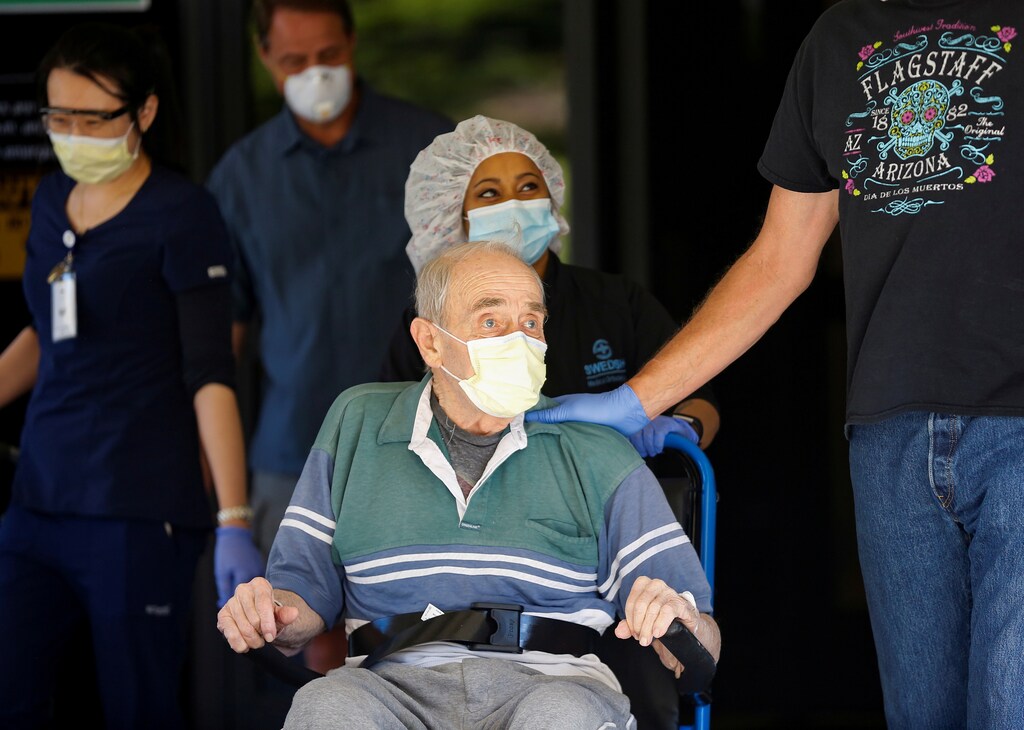 Gene Campbell, 89, who contracted coronavirus disease (COVID-19) at Life Care Center of Kirkland in early March, leaves Swedish Medical Center Edmonds with sons Todd Campbell, left and Charlie Campbell, right, after spending six weeks in the hospital in Edmonds, Washington, U.S. April 20, 2020. REUTERS/Lindsey Wasson TPX IMAGES OF THE DAY - RC2N8G9C9CZT