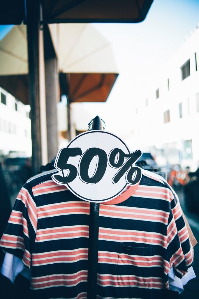 Experts have discussed how to make fashion, shown with this railing of clothes, more sustainable.