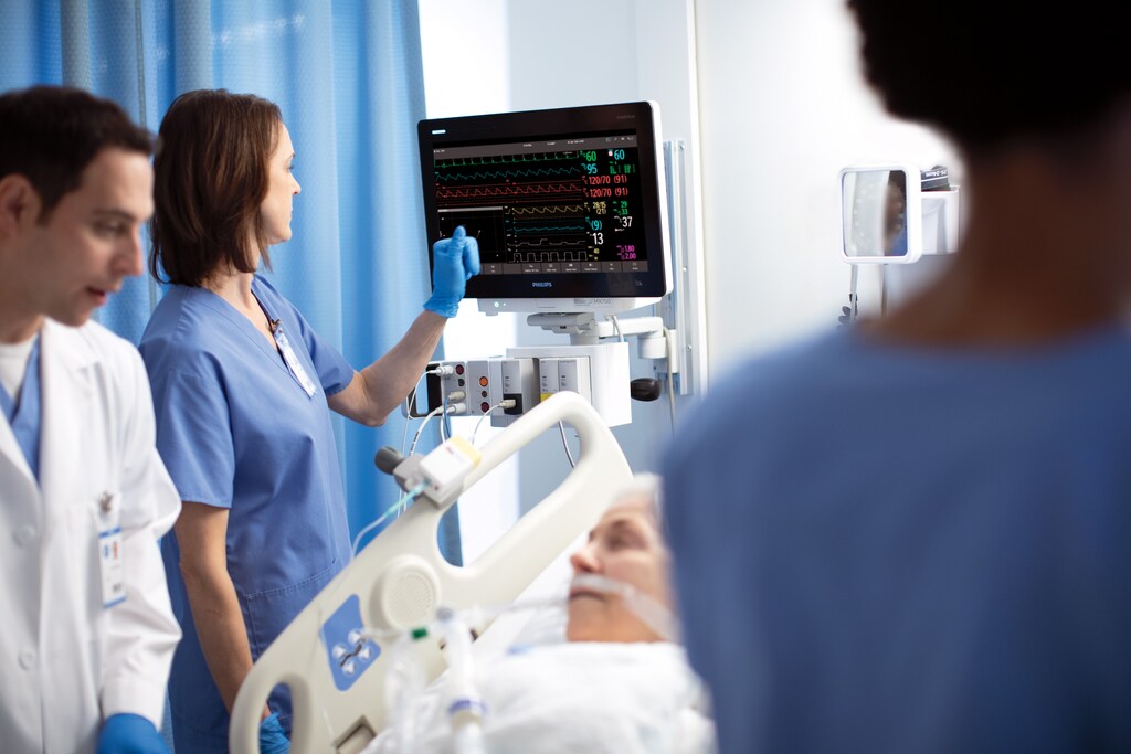Healthcare professionals reading data from a screen