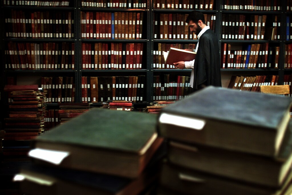 An Iranian religious student reads a book in the library of the Motaheri seminary in Tehran June 12, 2001. Country's President Mohammad Khatami, promising to press ahead with efforts to reform the Islamic Republic, was re-elected with 77 percent of the vote last weekend. The leading conservative candidate came a distant second with 15.6 percent.DS - RTRJFLC