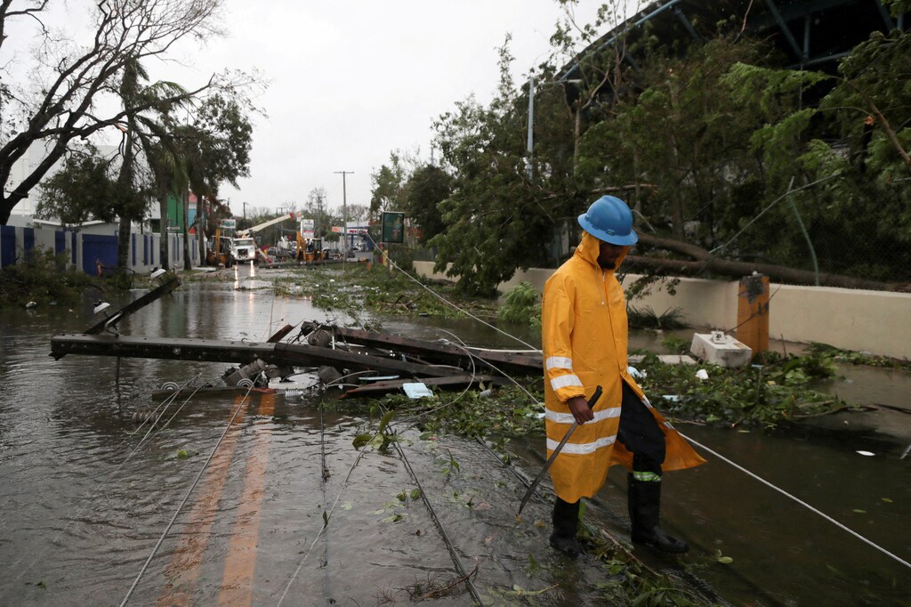A worker removes utility poles in the aftermath of Hurricane Fiona in Higuey, Dominican Republic, September 19, 2022. REUTERS/Ricardo Rojas/File Photo