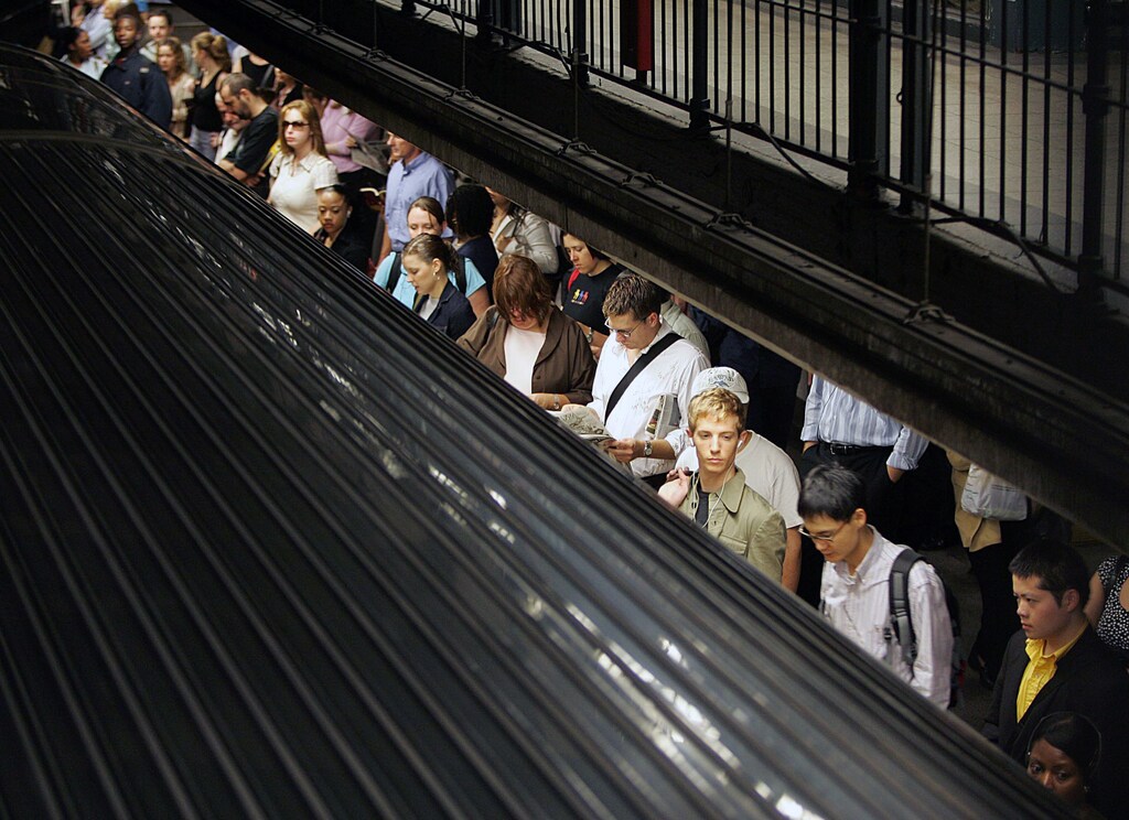 Commuters wait for the subway train to stop in New York City October 7, 2005. Part of the section of New York's Pennsylvania Station where Amtrak trains operate was sealed off on Friday morning because of what authorities said was a police situation, a day after officials warned of a possible attack on the system. The precaution came one day after New York officials said they had intelligence that the city's subway system was under a credible and specific threat of possible attack. REUTERS/Seth Wenig - RP2DSFIMBZAA
