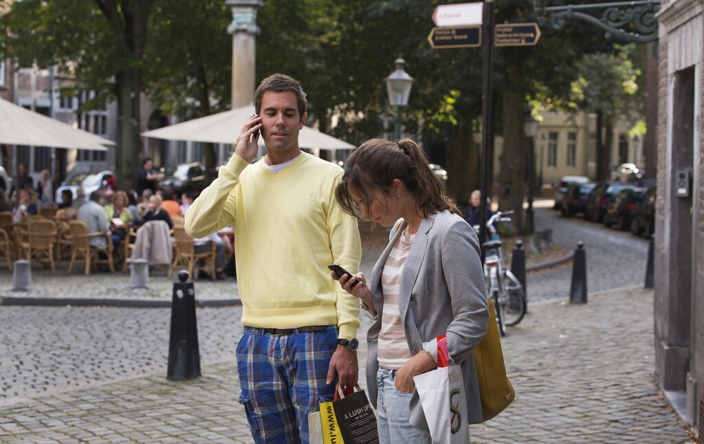 A couple uses their smartphones on the streets of Maastricht September 15, 2012.