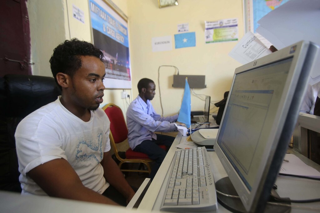 An internet cafe manager uses a computer in an internet cafe in the Hodan area of Mogadishu October 9, 2013. Reuters/Feisal Omar (SOMALIA - Tags: SOCIETY) - RTX14IOC