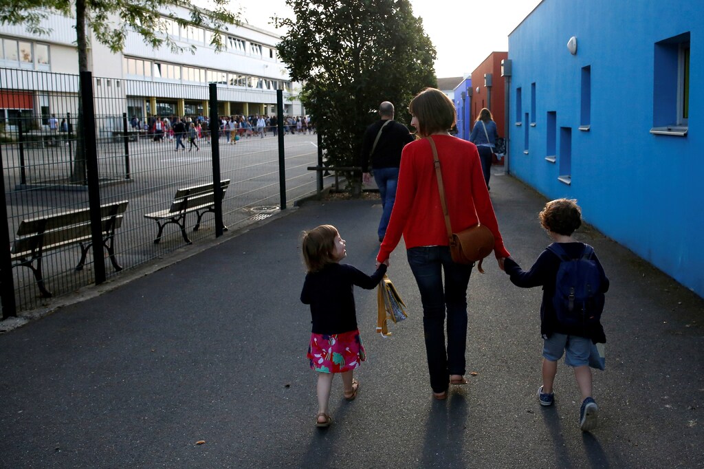 A mother and her children walk to arrive at the nursery school on the first day of the new school year in Vertou, France September 3, 2018. REUTERS/Stephane Mahe