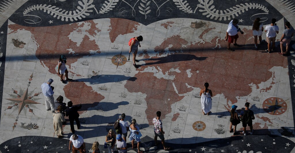 People take pictures at a square decorated with a giant world map in Lisbon, Portugal September 6, 2017. REUTERS/Rafael Marchante - RC15DA1863E0