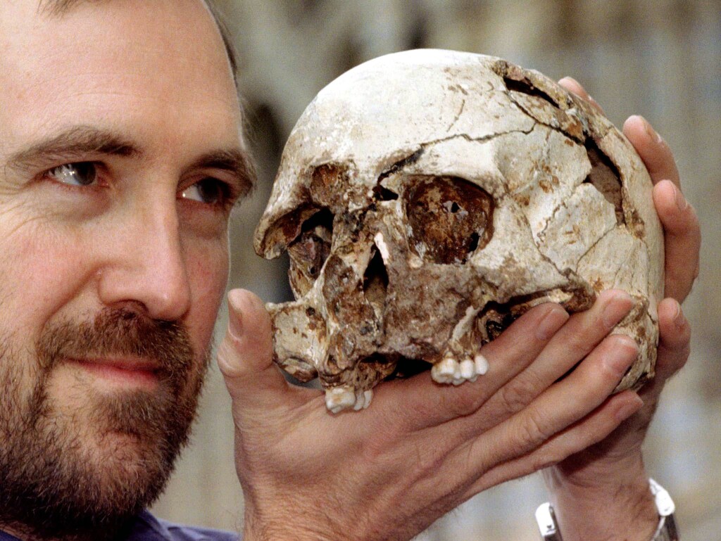 Dr. Chris Stringer, principal researcher of human origins at the Natural History Museum, holds the skull of the 'Cheddar Man' March 7. The 'Cheddar Man' who lived over 9,000 years ago in Cheddar Gorge has recently undergone a series of experiments to extract ancient DNA from his skull.