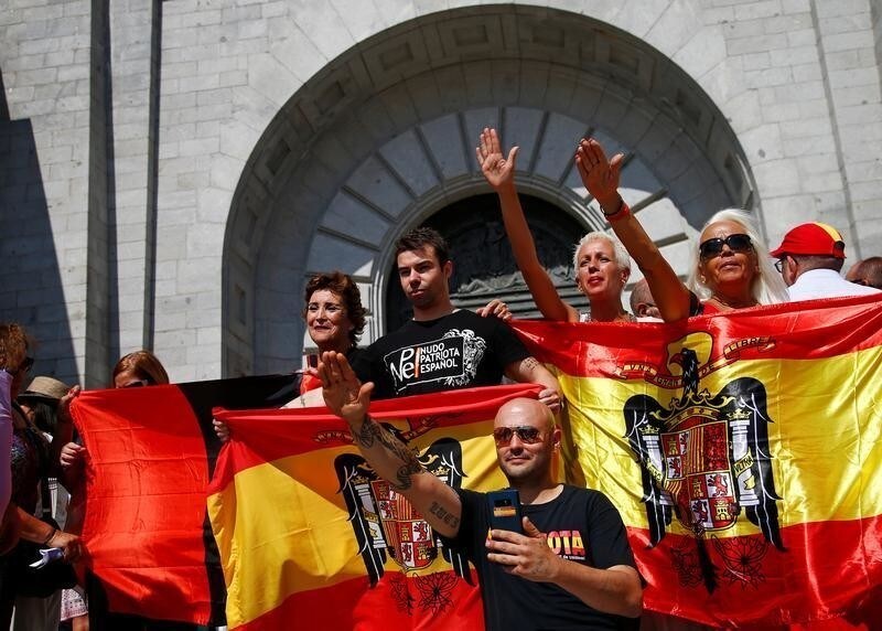 People attend a demonstration against plans by Spain's Socialist government to remove the remains of fascist dictator Francisco Franco from the Valle de los Caidos state-funded mausoleum and to transform the monument into a place to remember the civil war rather than glorify the dictatorship, in San Lorenzo de El Escorial, outside Madrid, Spain, July 15, 2018.
