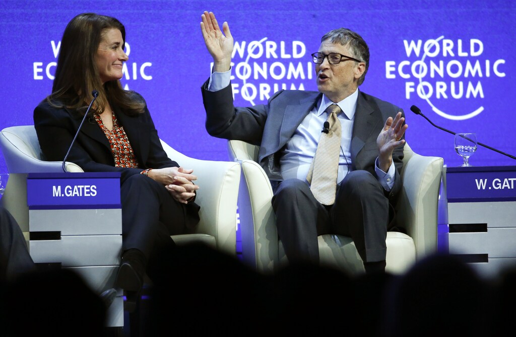 Bill Gates, Co-Chair of the Bill & Melinda Gates Foundation gestures next to his wife Melinda French Gates during the session 'Sustainable Development: A Vision for the Future' in the Swiss mountain resort of Davos January 23, 2015. More than 1,500 business leaders and 40 heads of state or government attend the Jan. 21-24 meeting of the World Economic Forum (WEF) to network and discuss big themes, from the price of oil to the future of the Internet. This year they are meeting in the midst of upheaval, with security forces on heightened alert after attacks in Paris, the European Central Bank considering a radical government bond-buying programme and the safe-haven Swiss franc rocketing. REUTERS/Ruben Sprich (SWITZERLAND - Tags: BUSINESS POLITICS TPX IMAGES OF THE DAY) - LR2EB1N1DUY4Z