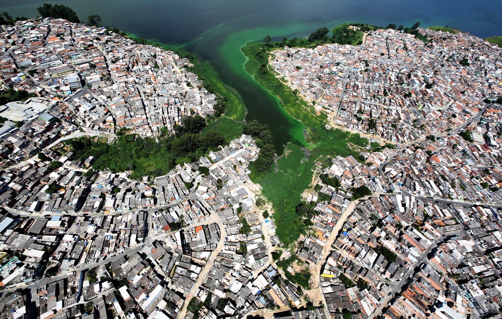 An aerial view shows illegally built slums on the border of the polluted water of Billings reservoir in Sao Paulo February 12, 2015. According to local media, the Billings dam supplies 1.6 million people in the Greater ABC region of Greater Sao Paulo and the state government wants to treat the water to be adequate for human consumption, adding to the complexity of securing safe water supply during the drought. Brazil is facing its worst drought in 80 years and its economy is already expected to post zero growth this year. Worse yet, since Brazil depends on hydroelectric dams for about three quarters of its electricity, power shortages are also possible due to the drought, federal officials have said. Picture taken February 12, 2015. REUTERS/Paulo Whitaker TPX IMAGES OF THE DAY - GF10000034742