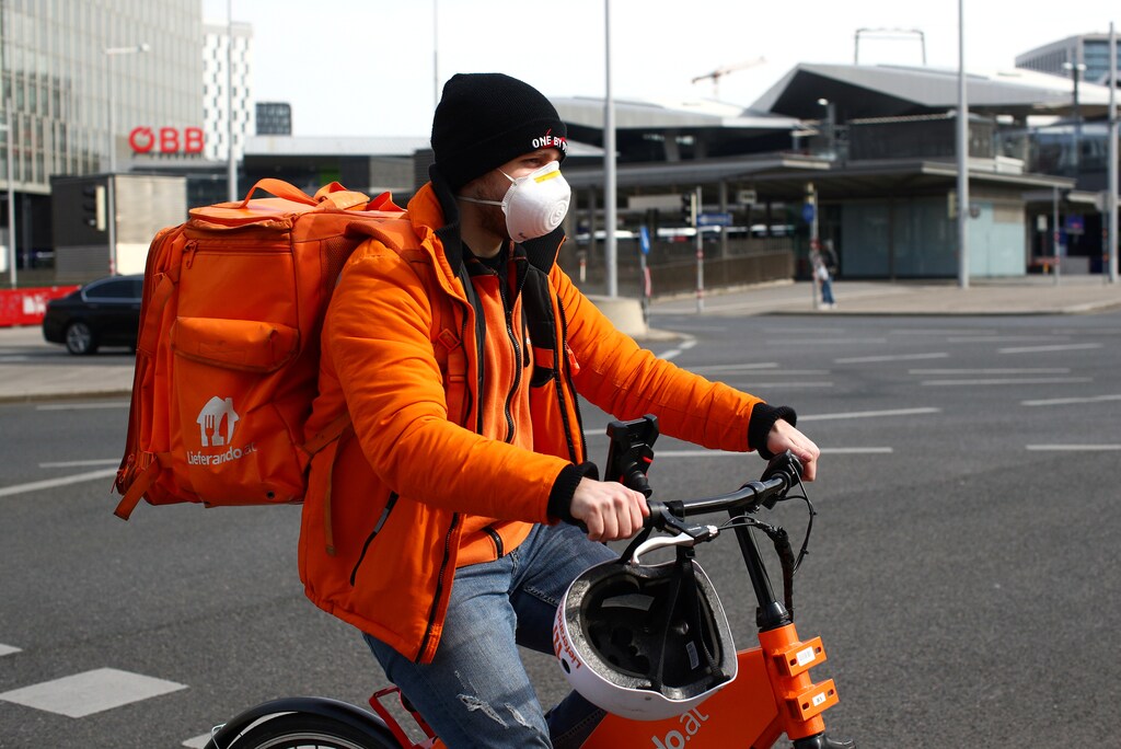 A food delivery worker wears a protective mask, during the coronavirus disease (COVID-10) outbreak, in Vienna, Austria March 26, 2020
