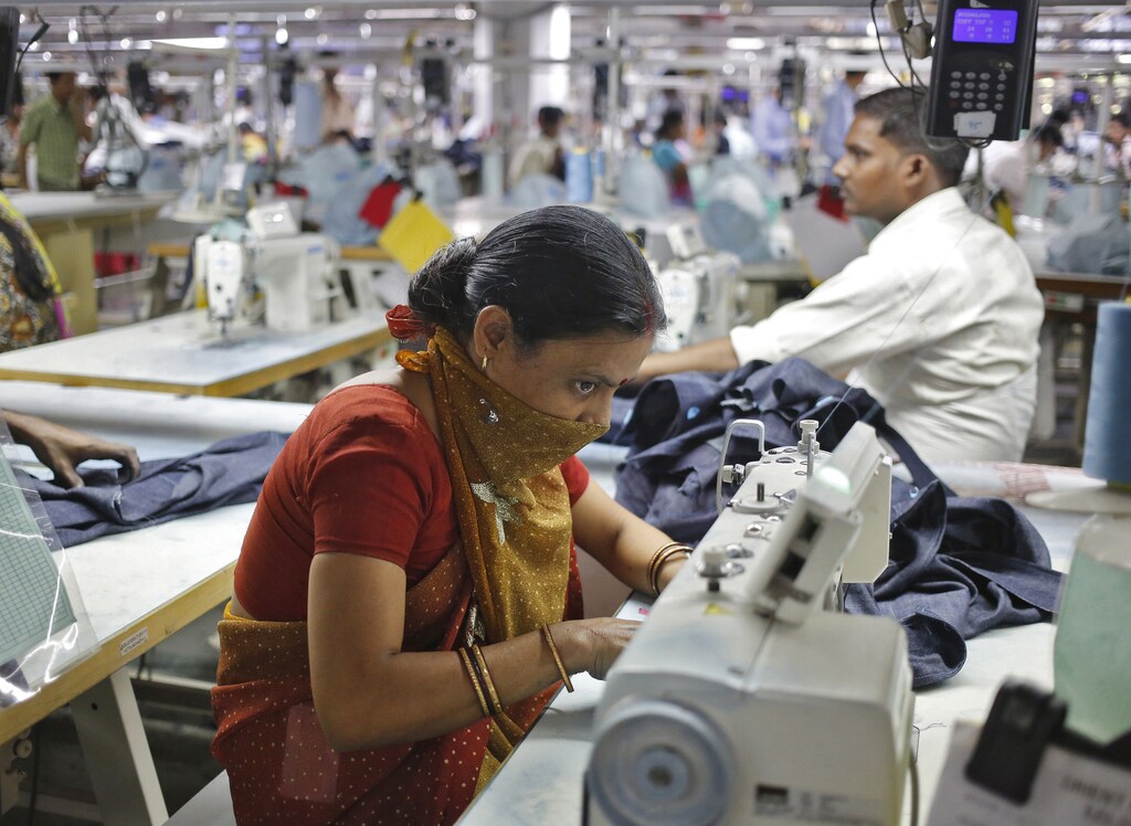 Employees work inside a textile mill of Orient Craft Ltd. at Gurgaon in Haryana, northern India April 16, 2014. When Narendra Modi talks about creating jobs in labour-intensive manufacturing, textile entrepreneur Sudhir Dhingra hopes the Indian opposition leader means business. Dhingra, who employs 30,000 workers in more than 20 factories around the capital New Delhi, says that politicians - for all their promises - have shown no interest in acting to avert a looming employment crisis. Early on, Dhingra survived a change of fashion that saddled him with a pile of unsold stock. Learning his lessons - to keep close tabs on the market and control costs - he built Orient Craft into $250 million business making 200,000 garments daily india women women men female male girls boys teenagers teens development gender gap parity equality diversity progress change feminine masculine woman man sex biology roles dynamic balance bias androgynous