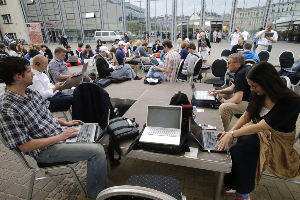 People use their laptops during "Working everywhere" event in Riga May 31, 2013. More than 150 activists with laptops and wi-fi access attended event to demonstrate the benefits of flexible working style and possibly set a new Guinness world record for "Most people who work in a specific place outside the office". REUTERS/Ints Kalnins (LATVIA - Tags: SOCIETY) - GM1E961053P01