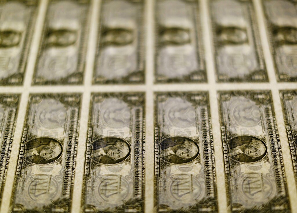 United States one dollar bills are seen on a light table at the Bureau of Engraving and Printing in Washington November 14, 2014.