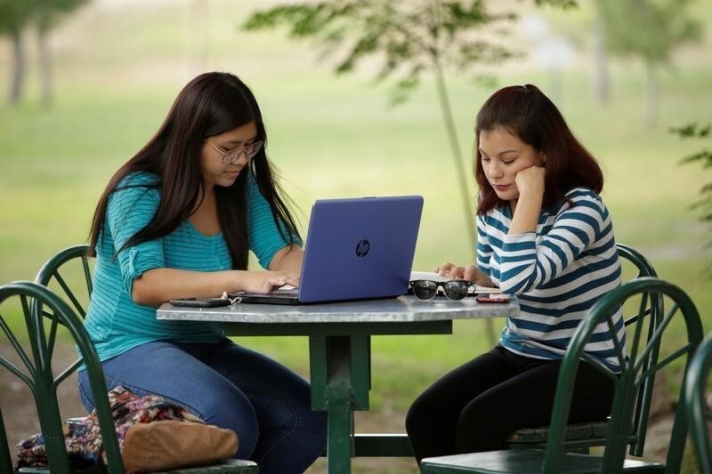 A woman works on her computer at a coffee shop in Ciudad Juarez, October 19, 2017. Picture taken October 19, 2017.
