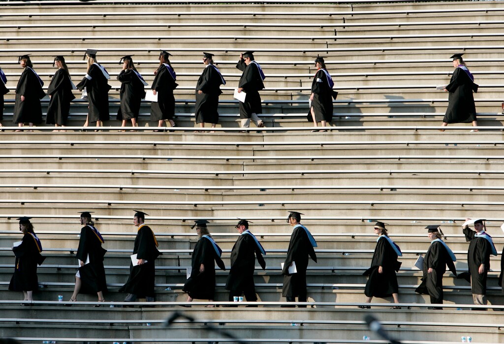 Graduating students enter the Paladin stadium before U.S. President George W. Bush watches them during the commencement ceremony at Furman University in Greenville, South Carolina May 31, 2008.