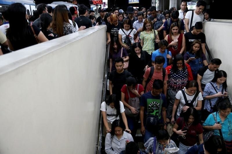 Janice Sarad, 22, who works for a bank, exits the Cubao MRT station in Quezon City, Philippines, December 3, 2018. Sarad sometimes takes the train to avoid the heavy traffic on the road. Trains to Metro Manila however are just as crowded as the traffic-congested roads, especially during rush hour. "It's really annoying how crowded it is sometimes. It becomes so smelly, so sweaty, you can even smell other people's breath," she said. REUTERS/Eloisa Lopez SEARCH "LOPEZ SARAD" FOR THIS STORY. SEARCH "WIDER IMAGE" FOR ALL STORIES. - RC1CA0930800