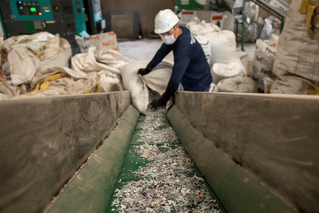 A worker loads shredded plastic to a machine to be molded into waterproof planks in the factory of social enterprise The Plastic Flamingo or The Plaf, in Muntinlupa, Philippines, October 18, 2021. The Plaf gathers plastics from restaurants, companies, and consumers and transforms them into useable raw material like waterproof planks. Picture taken October 18, 2021. Many entrepreneurs are seeing the world’s challenges as opportunities to build socially minded businesses.