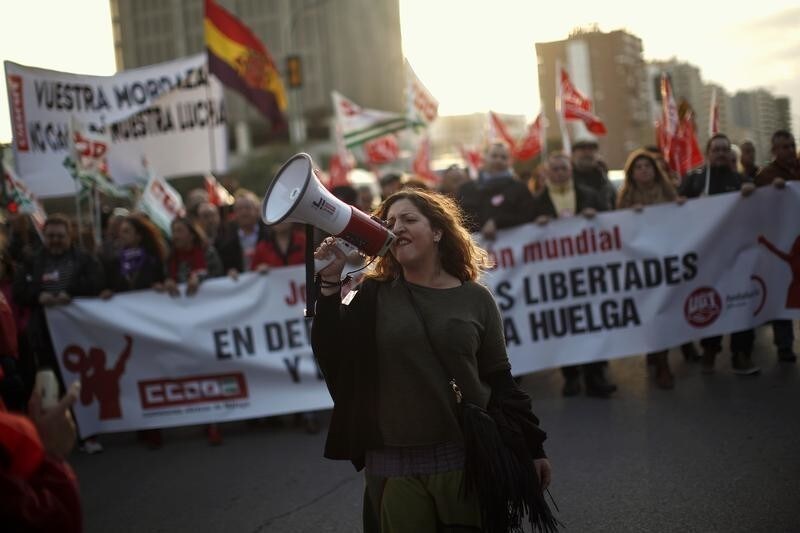 Workers and members of the labour union Comisiones Obreras (CCOO) and the General Workers Union (UGT) demonstrate during the Global Day of Action for the Right to Strike, in Malaga, southern Spain, February 18, 2015. The International Trade Union Confederation (ITUC) called for demonstrations around the world in defense of freedom and the right to strike. The banner (bottom) reads: "Global Day of Action. In defense of freedom and the right to strike". REUTERS/Jon Nazca (SPAIN - Tags: POLITICS CIVIL UNREST) - GM1EB2J0DFI01