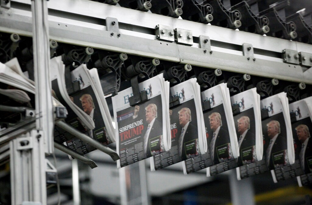 Freshly printed newspapers with the headline reading "Trump surprises" are seen at a conveyer belt at a printer of the local daily El Diario of Juarez in Ciudad Juarez, Mexico, November 9, 2016. REUTERS/Jose Luis Gonzalez - RTX2STGJ