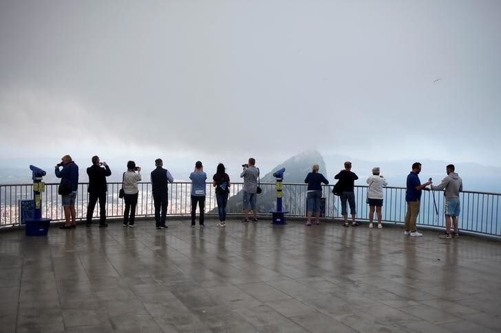 Tourists take photographs at a terrace on the top of the Rock in the British overseas territory of Gibraltar, historically claimed by Spain April 18, 2018. REUTERS/Jon Nazca