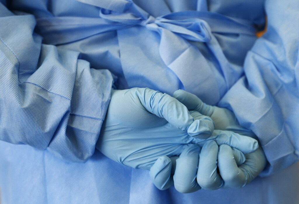The gloved hands of an army nurse are seen during a demonstration of an isolation chamber for the treatment of infectious disease patients, at the Germany army medical centre, Bundeswehr Clinc, in Koblenz October 16, 2014. The worst Ebola outbreak on record has killed more than 4,000 people -- mostly in Liberia, Sierra Leone and Guinea -- and has spread beyond West Africa, with a nurse in the United States and one in Spain having caught the disease from patients. REUTERS/Ralph Orlowski (GERMANY - Tags: HEALTH MILITARY TPX IMAGES OF THE DAY) - LR1EAAG0ZTX5Q